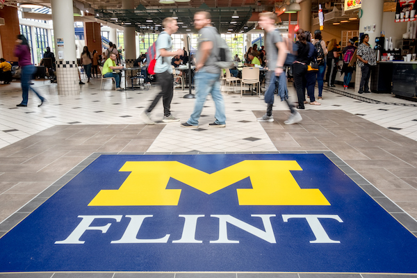 Students walk through the first floor of the University Pavilion.