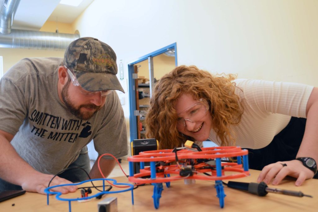 Engineering students inspect their drone