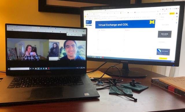 Photo of a laptop showing students from UM-Flint and Colombia