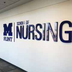 School of Nursing sign on the walls of the White Building
