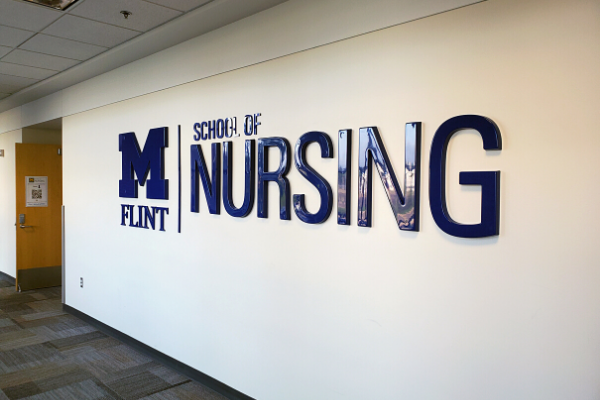 School of Nursing sign on the walls of the White Building