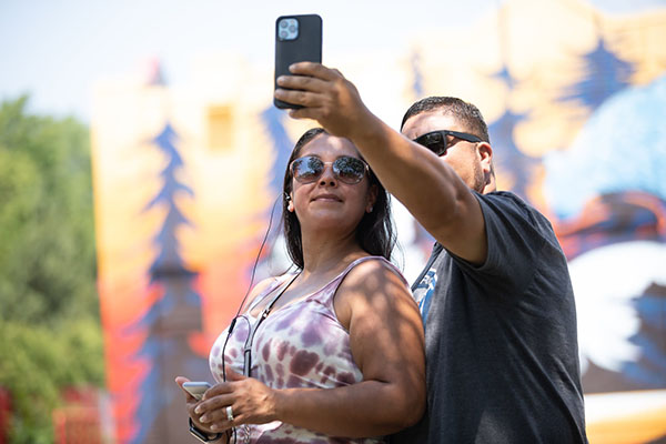 Photo of people taking selfie with cell phone