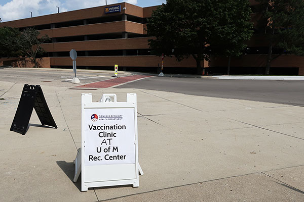 A sign promoting vaccine clinics on campus