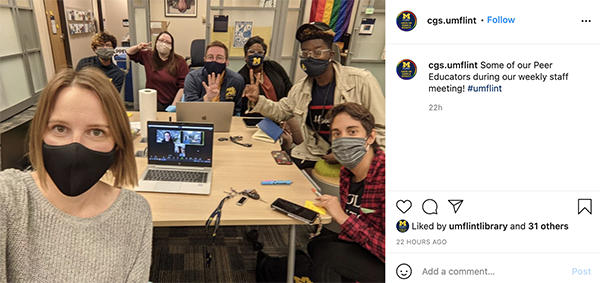 A group of students wearing masks posing for the camera. 