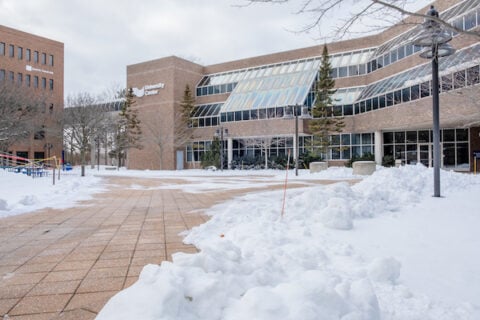 McKinnon Plaza and the University Center in the winter. Snow covers the ground.