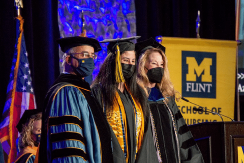 A graduate on stage with the chancellor
