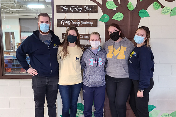 DPT Students stand in front of Giving Tree at Food Bank of Eastern Michigan