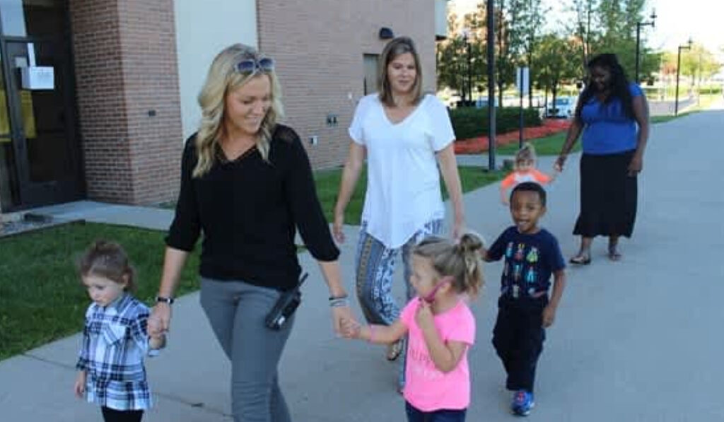 Staff from the Center for Educator Preparation with children at William S. White Building