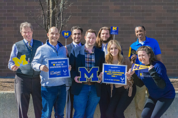 Entrepreneurs Society members with Giving Blueday signs