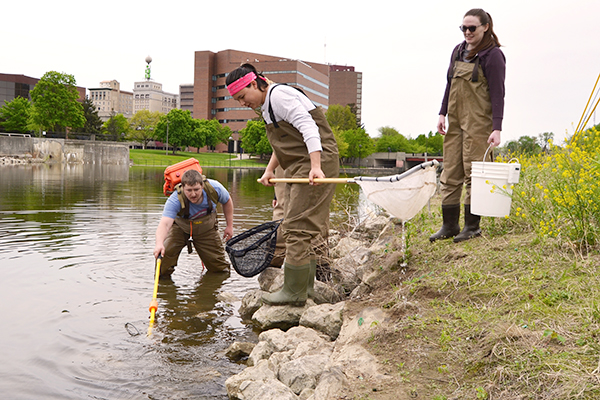 UM-Flint students fish in the Flint River. 