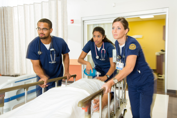 Student nurses simulating treating a patient