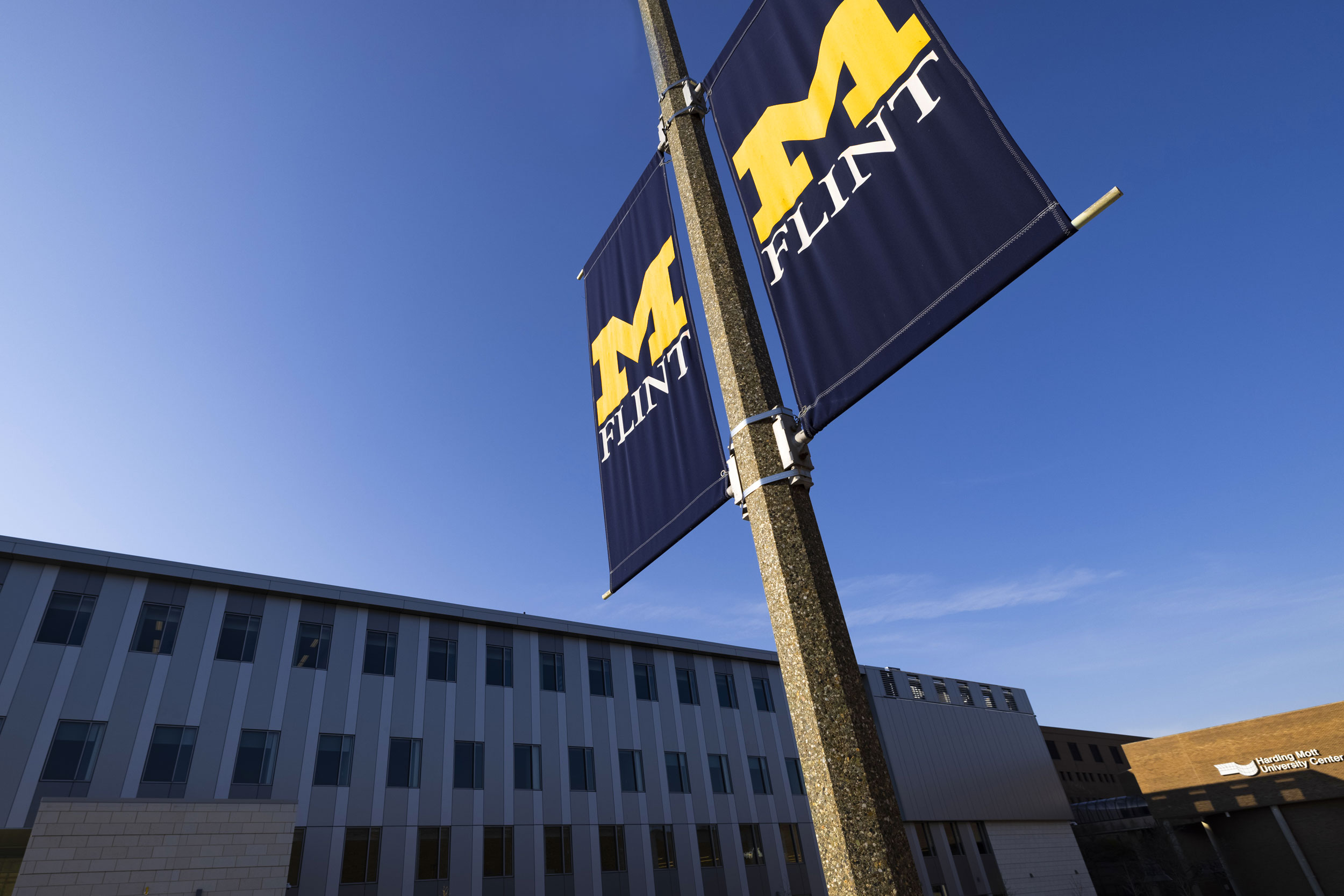 A UM-Flint banner outside of the Murchie Science Building Expansion