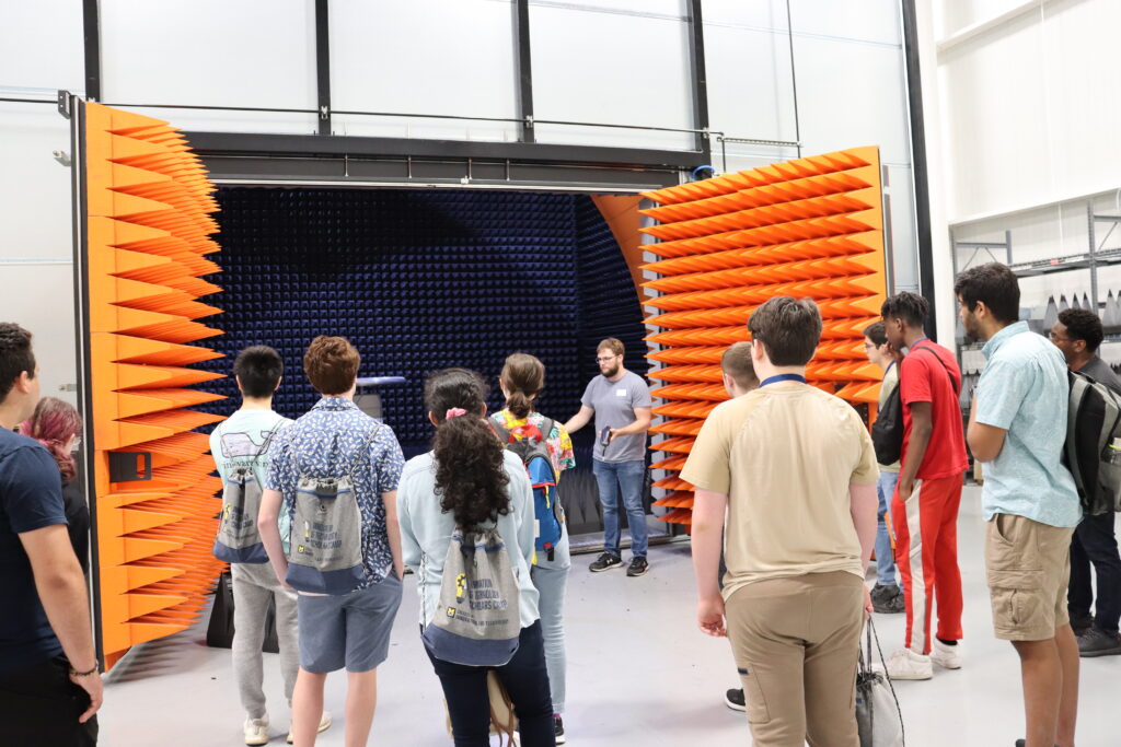 Students in front of a large anechoic chamber