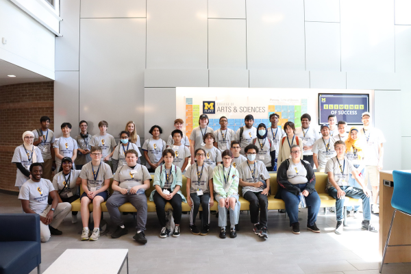 The group of CIT campers posing in front of the Elements of Success, a periodic table with donor names