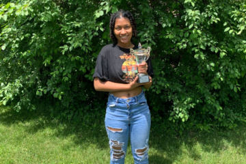 CEO student Savannah Williams poses with her Director's Cup trophy.