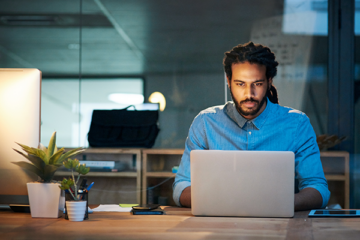 A man working on a laptop at a desk