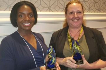 Sade Wilson and Michelle Silva holding their awards