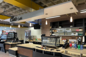 The counter at Clint's Cafe in the UCEN, which has coffee equipment and a pastry case.