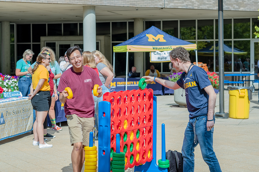 Students playing giant Connect Four in MicKinnon Plaza. 