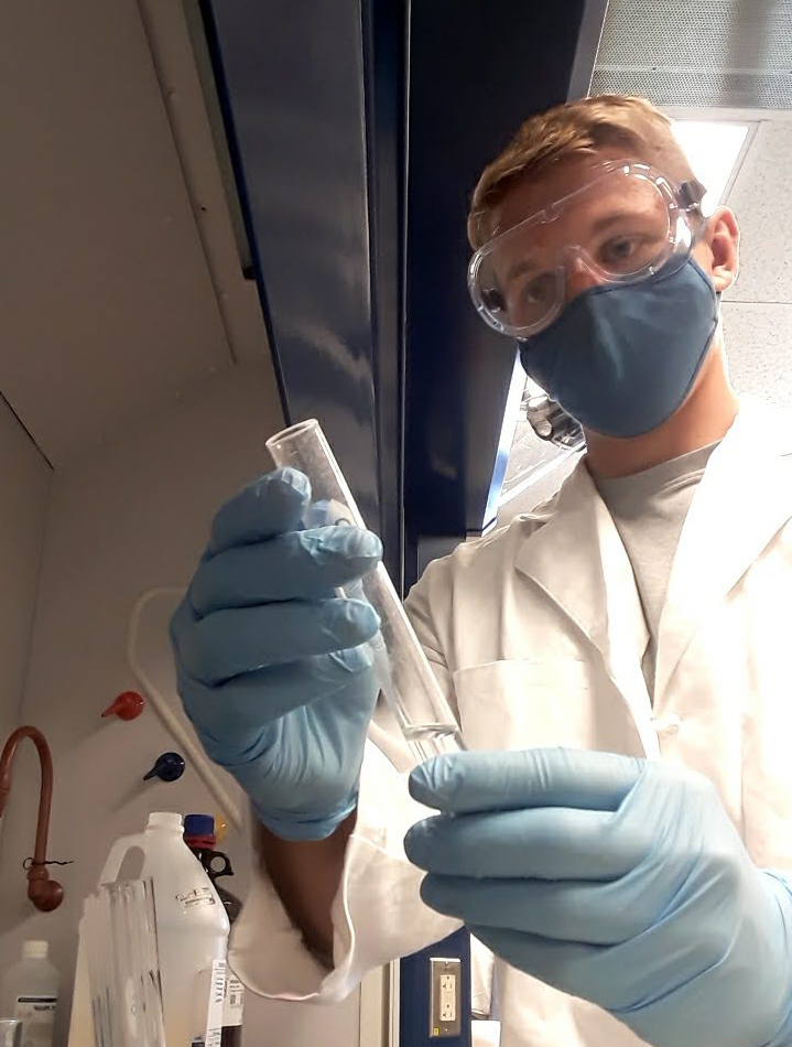 Matthew Thelen wearing personal protective equipment working in the laboratory. 