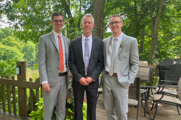 Drew, Andy and Ben Cooper stand together