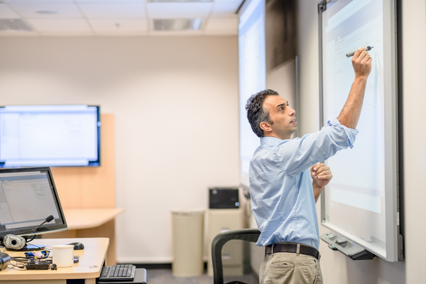 Bisgin writing on a whiteboard