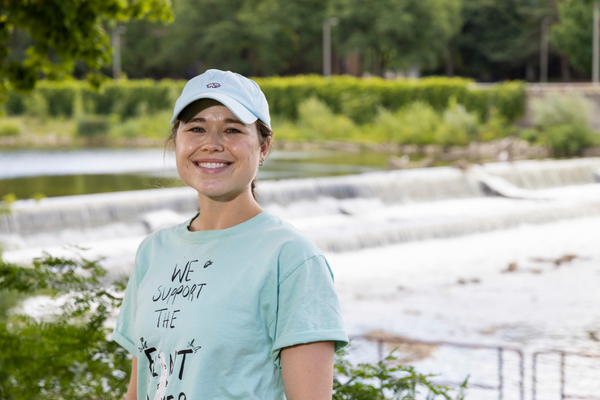 Chloe Summers smiles for a portrait in front of the Flint River, with the Flint River inthe background