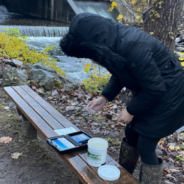 Student takes water sample