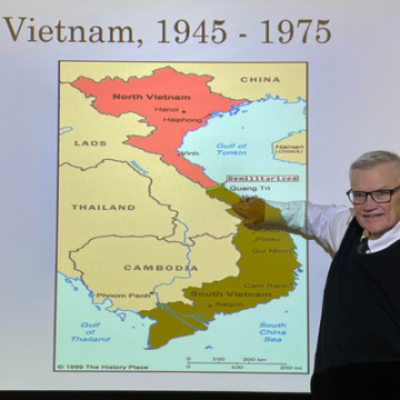 Havrilcsak pointing to Vietnam on a map. 