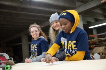 Three students working on a construction project