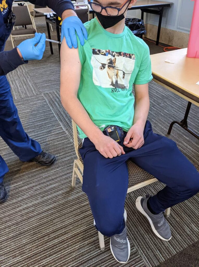 A teenager receiving a covid vaccination