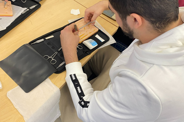 A student practicing sutures. 