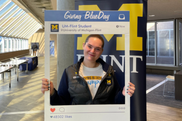 Tabitha Robinson posing with a recreation of an instagram photo frame