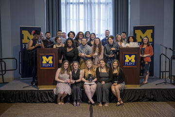 UM-Flint winners of Celebrating Wolverine Excellence awards gather for a photo in the Northbank Center.