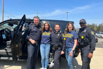 Members of the UM-Flint “Officer Friendly Day” team include Ray Hall, director of public safety; Melissa Sreckovic, associate professor of education; Heather Bromley, police sergeant; Christine Kenney, associate professor of education; and Torrey Ruffin, police officer.