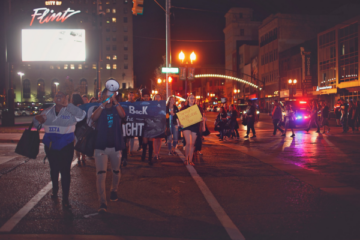 UM-Flint students march on Saginaw Street in downtown Flint during Take Back the Night, an event to honor sexual assault survivors.