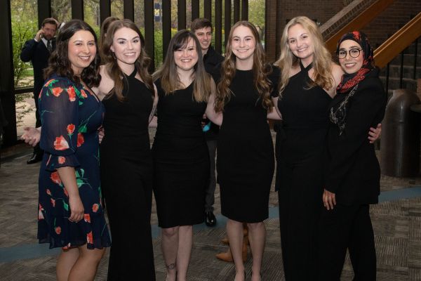 Six PA graduates pose for a photo at a ceremony celebrating their graduation, April 29.