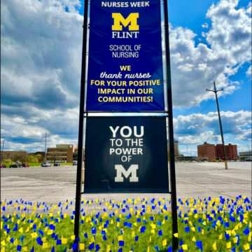 Photo of Maize & Blue flags with a nurses week banner