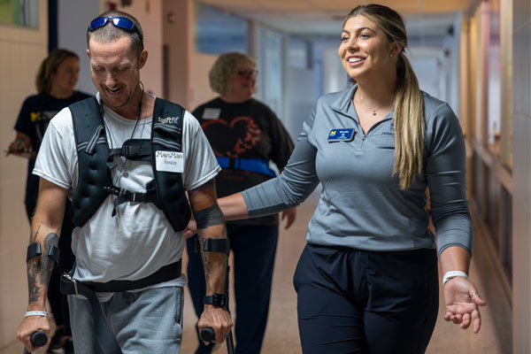 Mazzolini works with a patient at the HEART clinic.