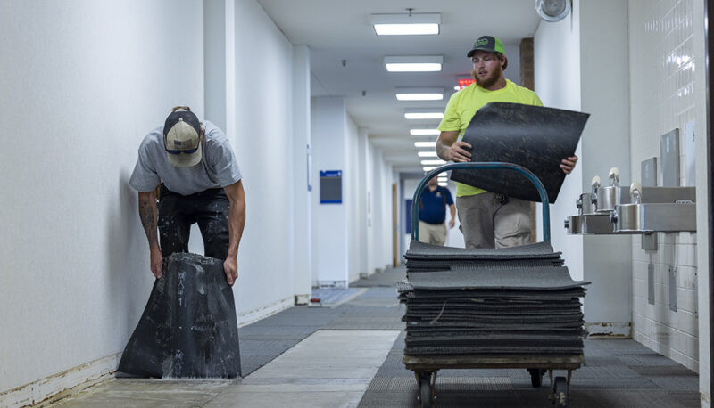 Workers installing carpet