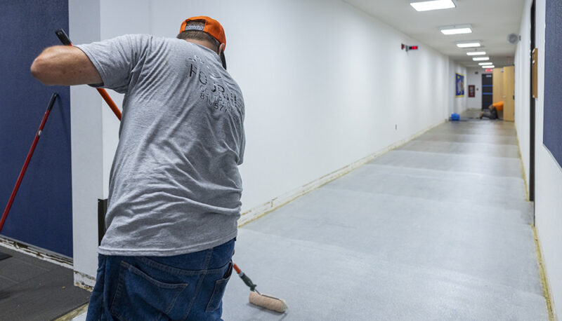 A worker preparing the floor for carpet