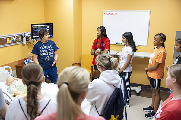 High school campers learn nursing practices from professionals (Debbie Ryan) in the University’s Simulation and Clinical Innovation Center