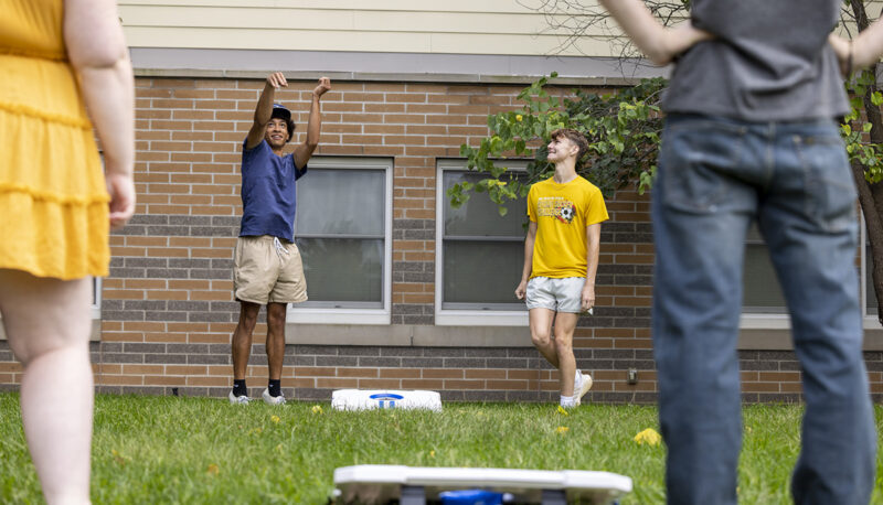 Students playing cornhole