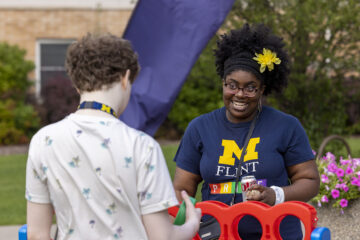 Two members of the UM-Flint community playing Connect 4.