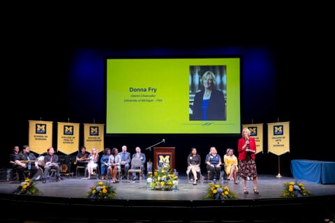 A shot of the Academic Convocation Stage with Interim Chancellor Donna Fry speaking.