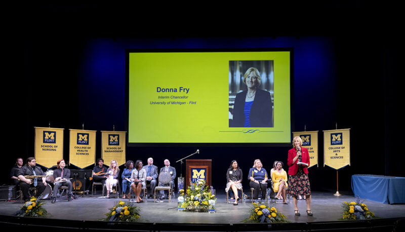 A shot of the stage and Donna Fry speaking at Academic Convocation