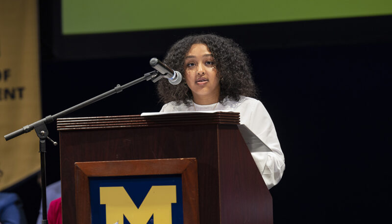 UM-Flint Student Government president Lina Azeim speaking at a podium