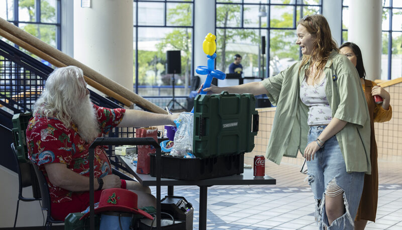 A student taking a balloon animal