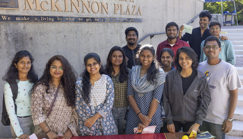 A group of students posing in McKinnon plaza