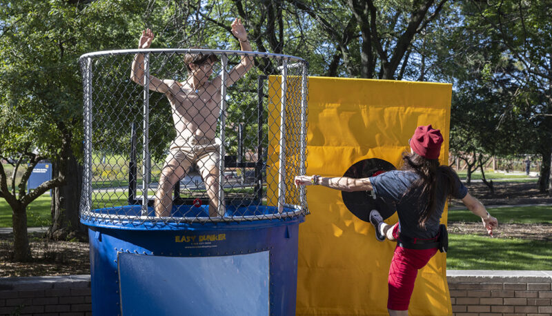 A professor dunking a student in a dunk tank